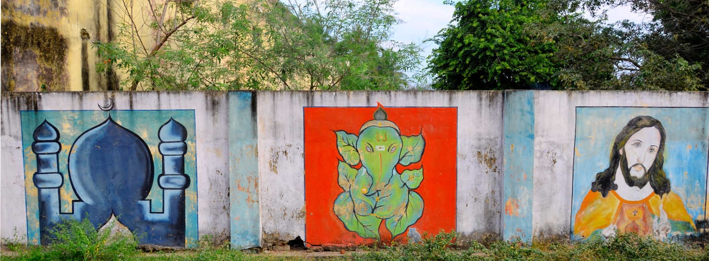 cemetery wall with multiple religious paintings